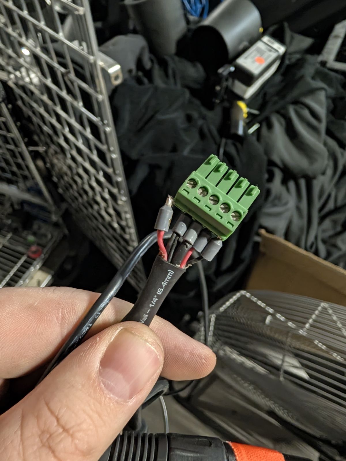 A broken cable: loose wires with crimped tips going into a green connector